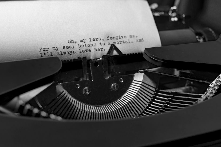 Close-up of a vintage typewriter typing an emotional message on a piece of paper.